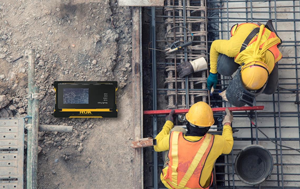 Construction workers on concrete form next to ROK device